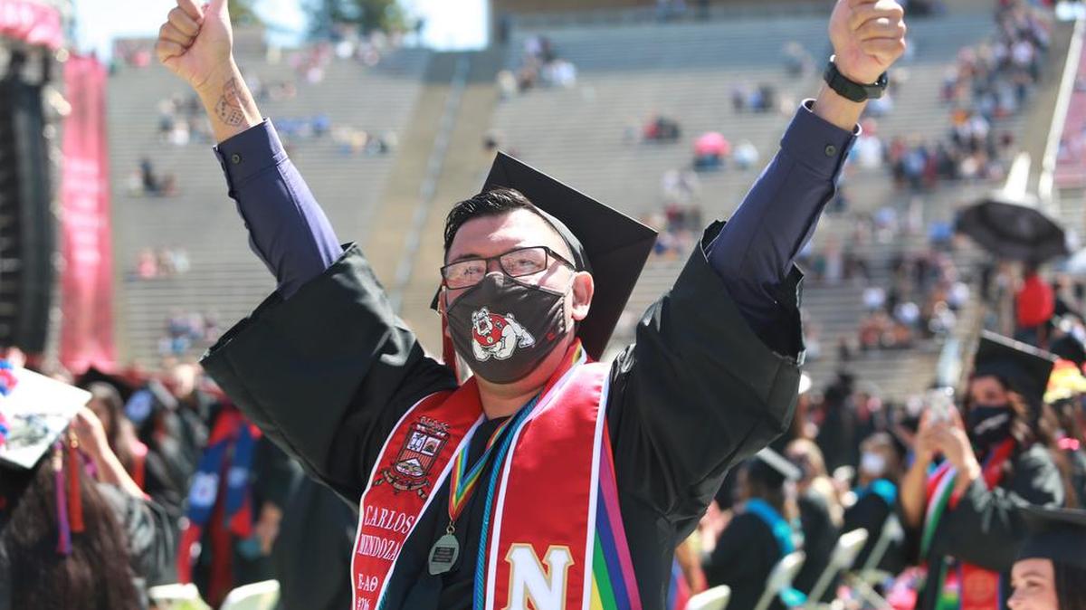 A Fresno State graduate Carlos A. Mendoza celebrates during the May 15, 2021 morning commencement at Bulldog Stadium.