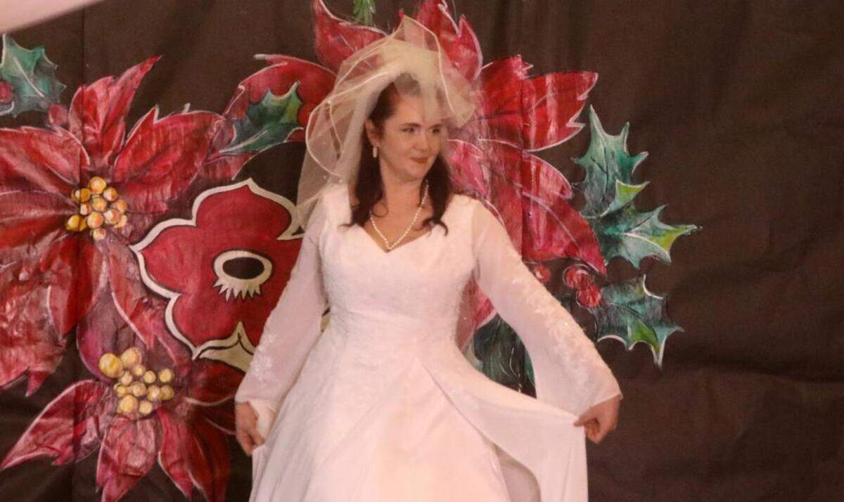 Tiffany Nab models a wedding dress during the 47th Fiesta Navideña Fashion Show at Fresno Fields on Dec. 4, 2022. The fundraiser was sponsored by the League of Mexican American Women.