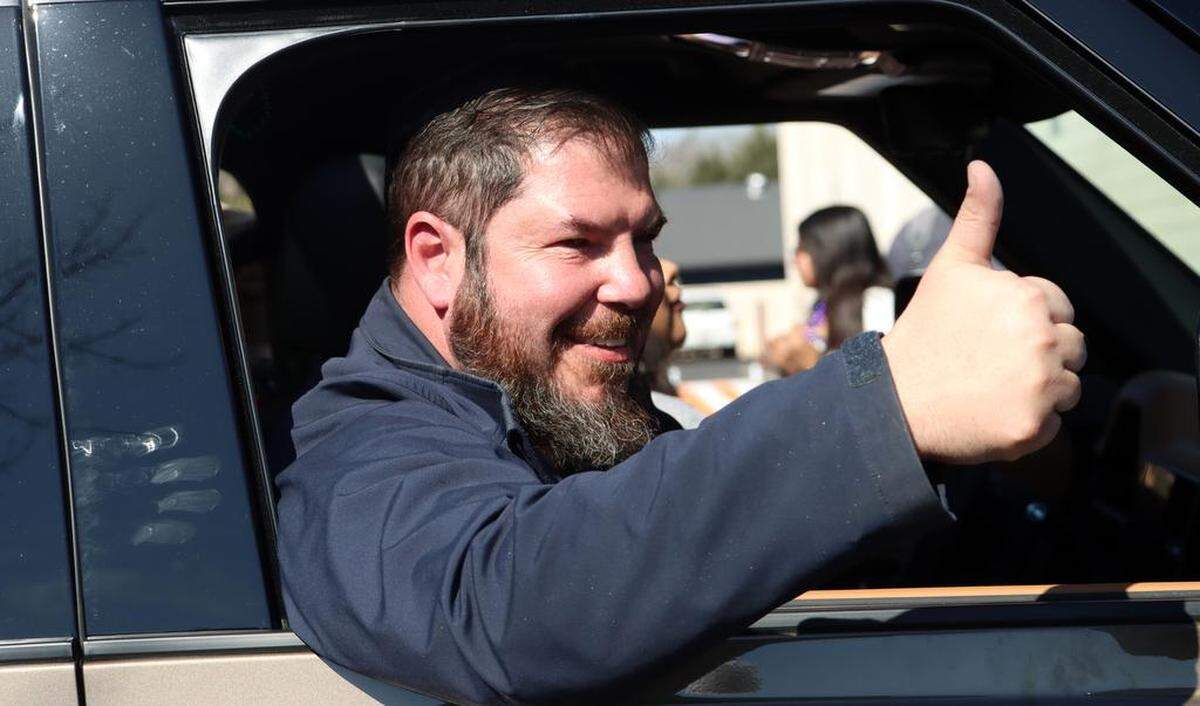 Assemblymember Joaquín Arámbula waves at spectators during the 25th annual Mardi Gras Parade in the Tower District on Feb. 19, 2023.