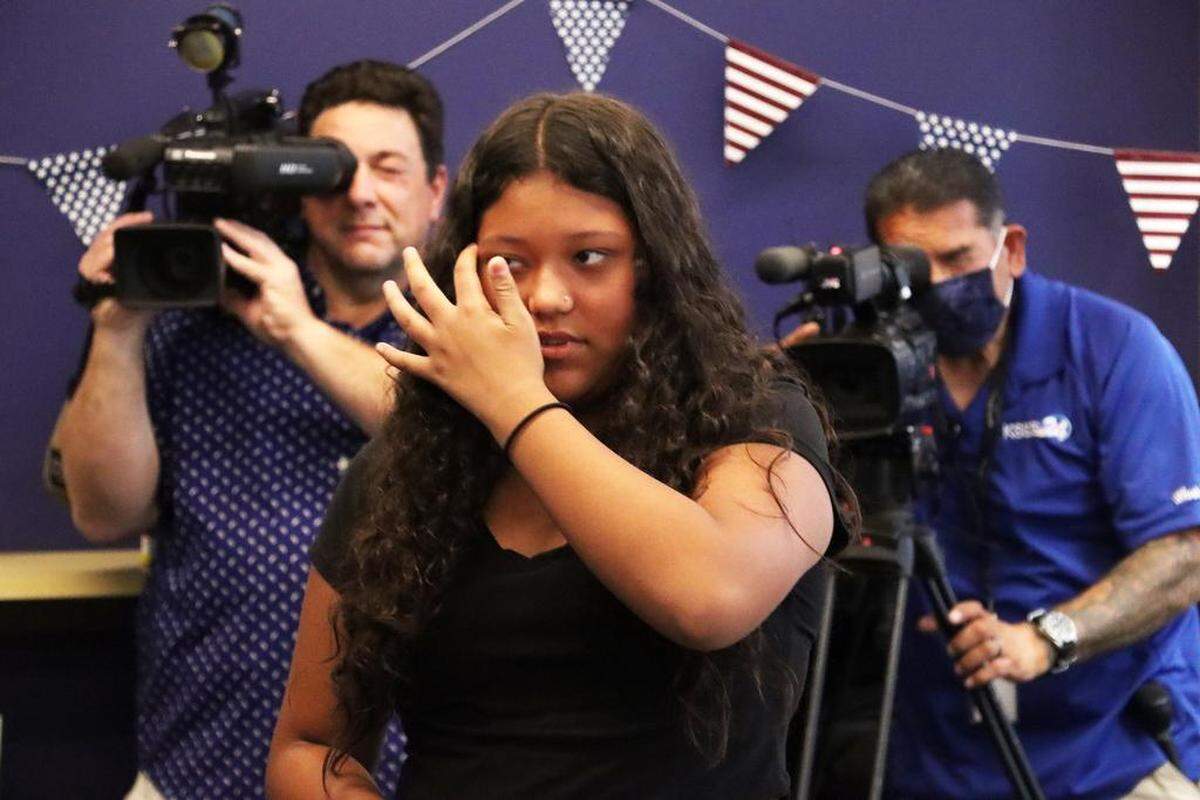 Alondra Núñez walks to get her naturalization certificate during a Sept. 16, 2022 ceremony at the the Betty Rodríguez Regional Library in observance of Citizenship Day.