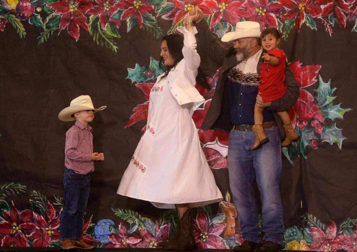Ben and María Klassen dance with son Rubén during the 47th Fiesta Navideña Fashion Show at Fresno Fields on Dec. 4, 2022. The fundraiser was sponsored by the League of Mexican American Women.