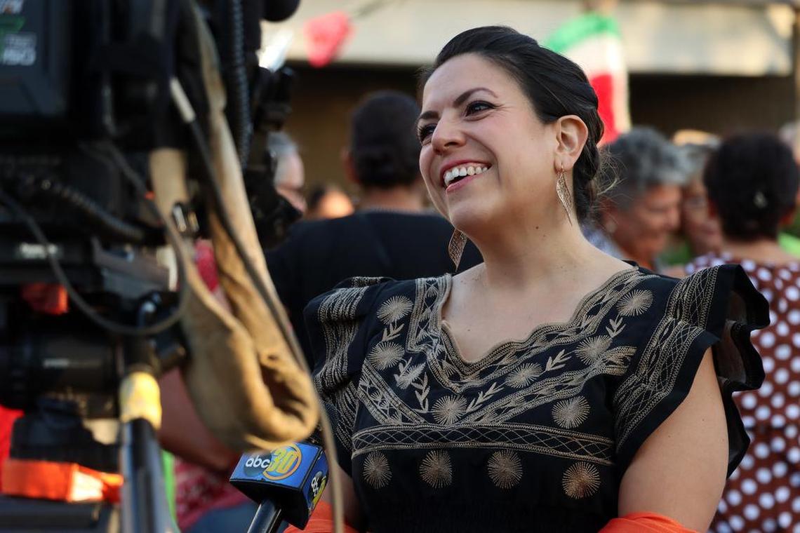 Mexican Consulate staff member Nuria Zuñiga gets interviewed by a television station during the Mexican Independence Day celebration at the Mexican Consulate in Fresno on Sept. 15, 2022.