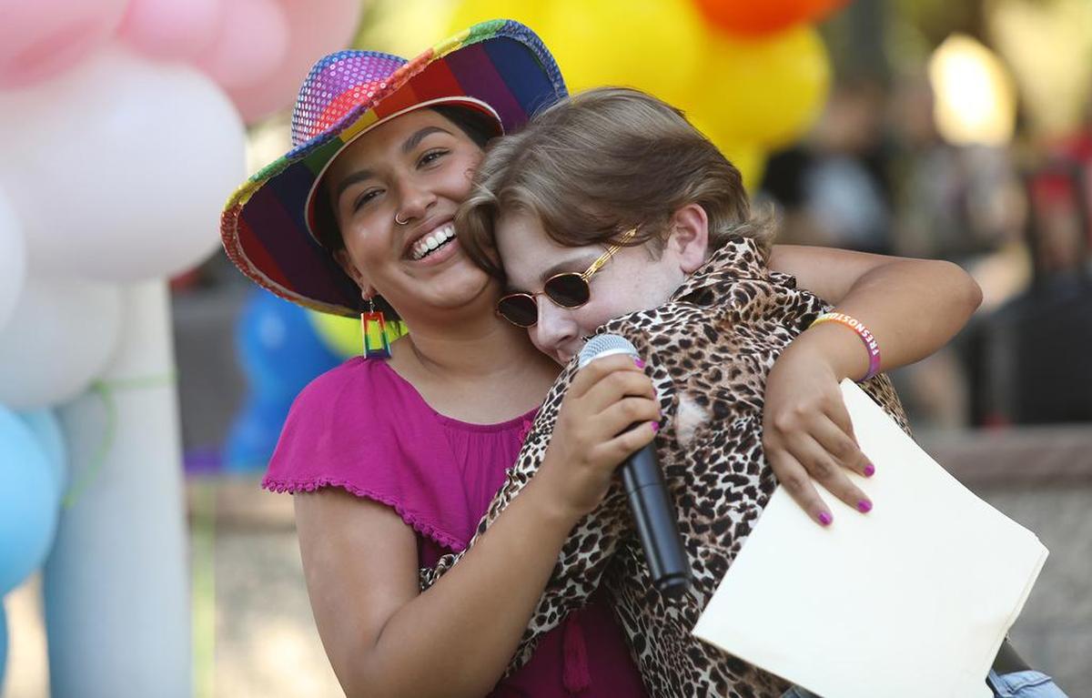 Zach M. Howell gets a hug from Kingsburg City Councilmember Jewel Hurtado after she presented him with a Sylvia Rivera Bravery Award.