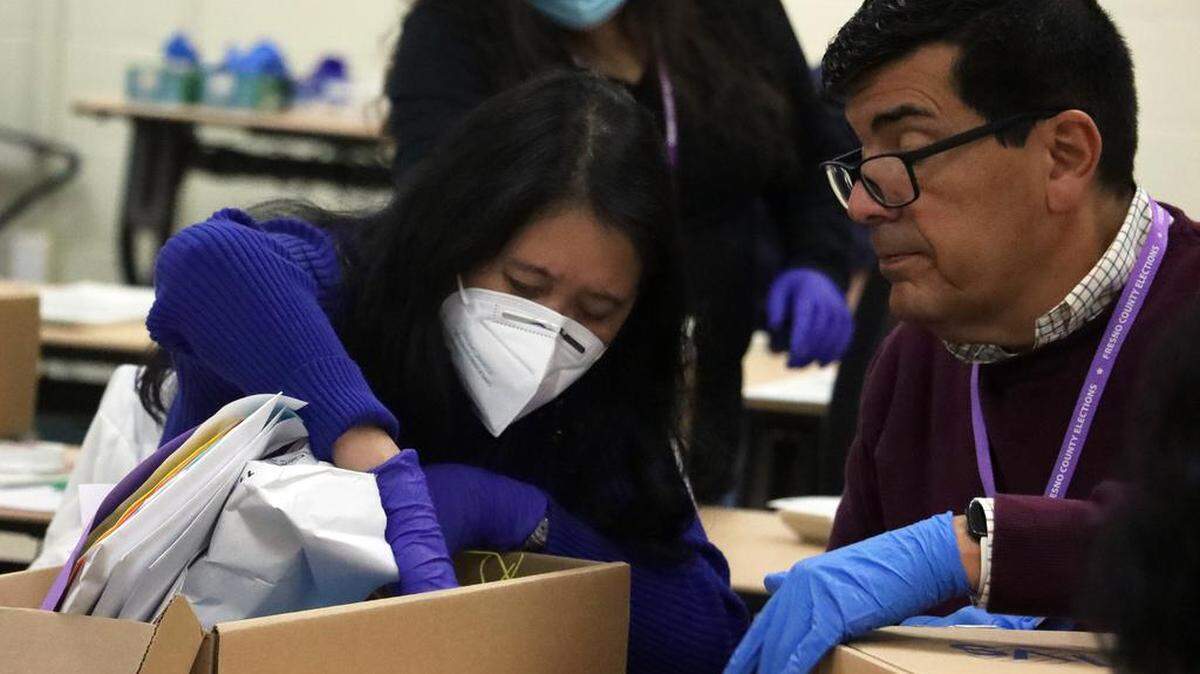 Fresno County Elections workers sift through ballots at the start of a recount in the state Senate District 16 race between winning incumbent Melissa Hurtado and Republican challenger David Shepard at a county warehouse on Dec. 20, 2022. Officials expect the recount to take five days or more to complete.
