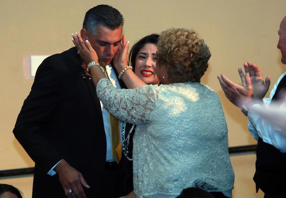 Henry ‘Hank’ Gutiérrez is congratulated by his mother, Henrietta, and wife, Lisa, when he was named Fresno County administrator of the year in 2014.