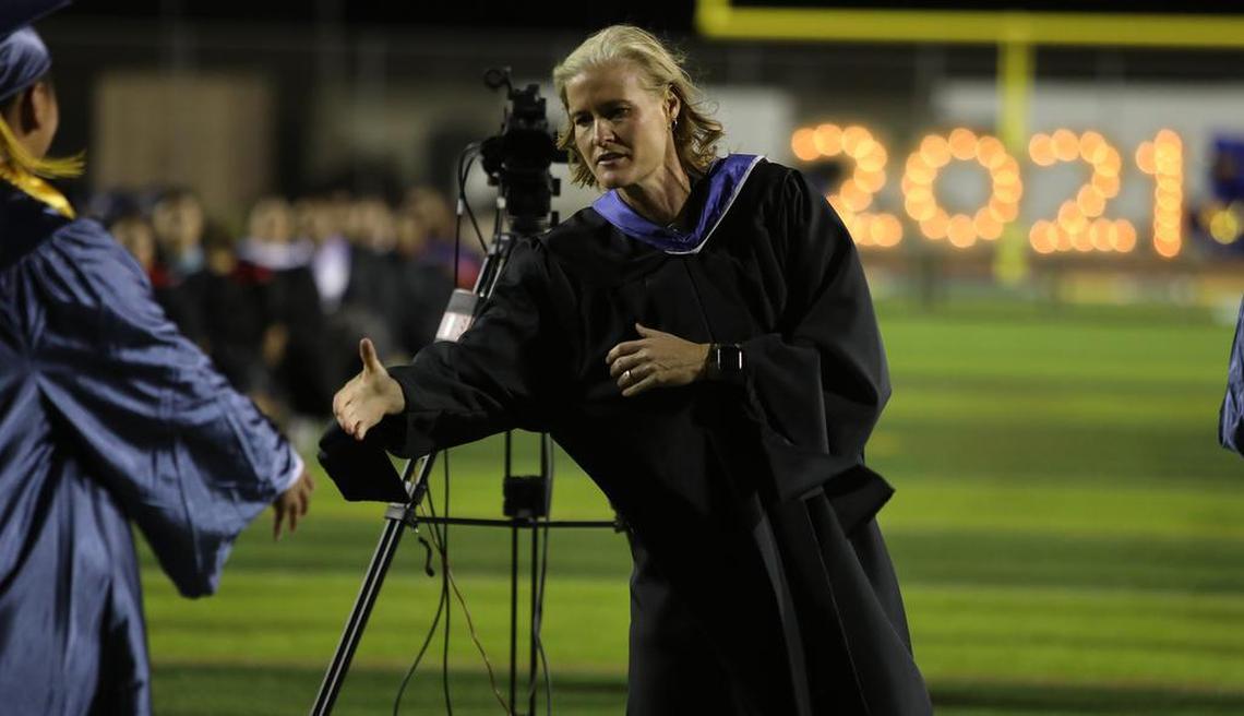 Sunnyside High Principal Michele Anderson congratulates a graduate from the Class of 2021 during the first-ever graduation ceremony held outdoors on June 6, 2021.