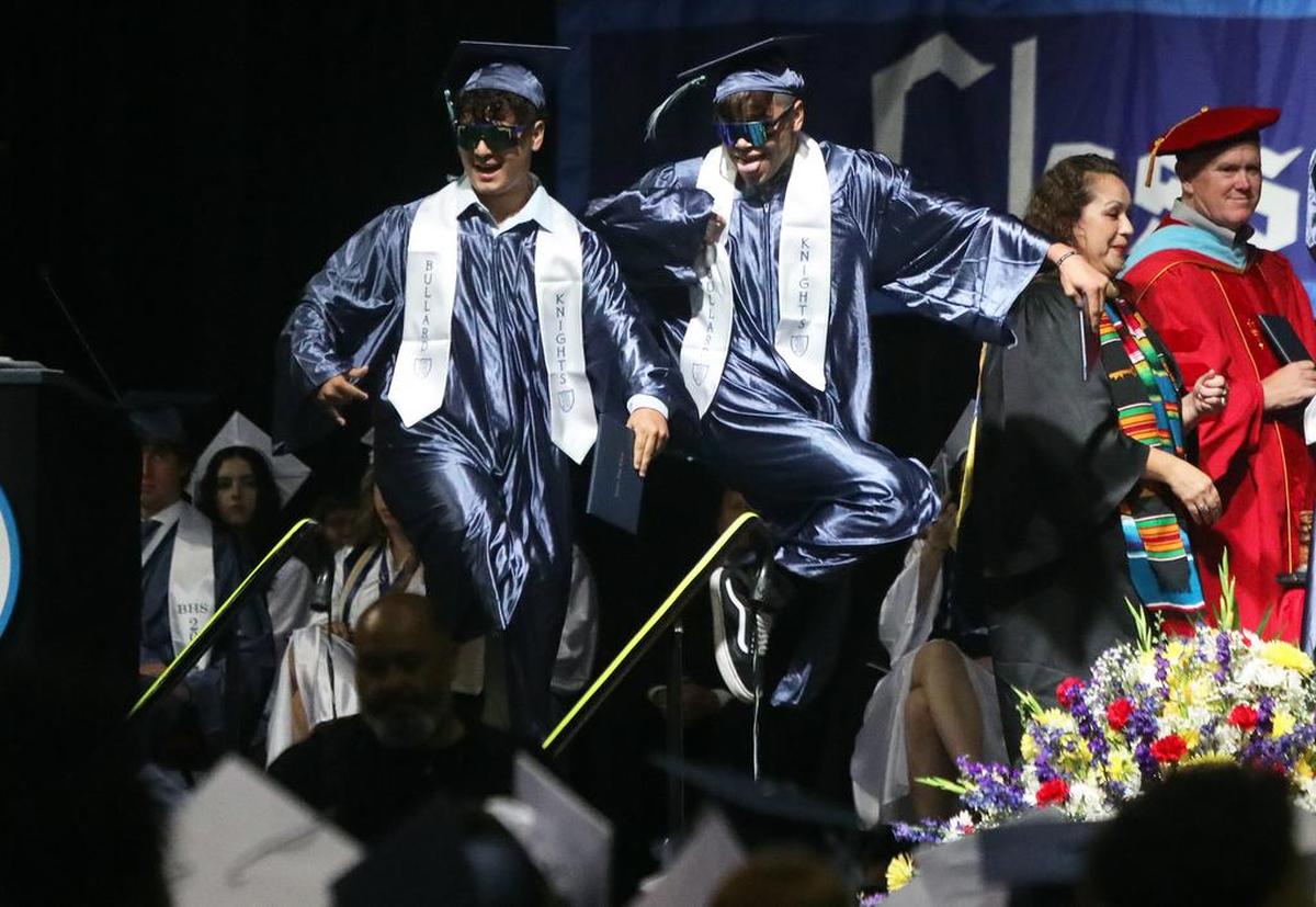 Two Bullard High School graduates do a dance on stage after getting their diplomas during June 8, 2022 graduation ceremony at the Save Mart Center.