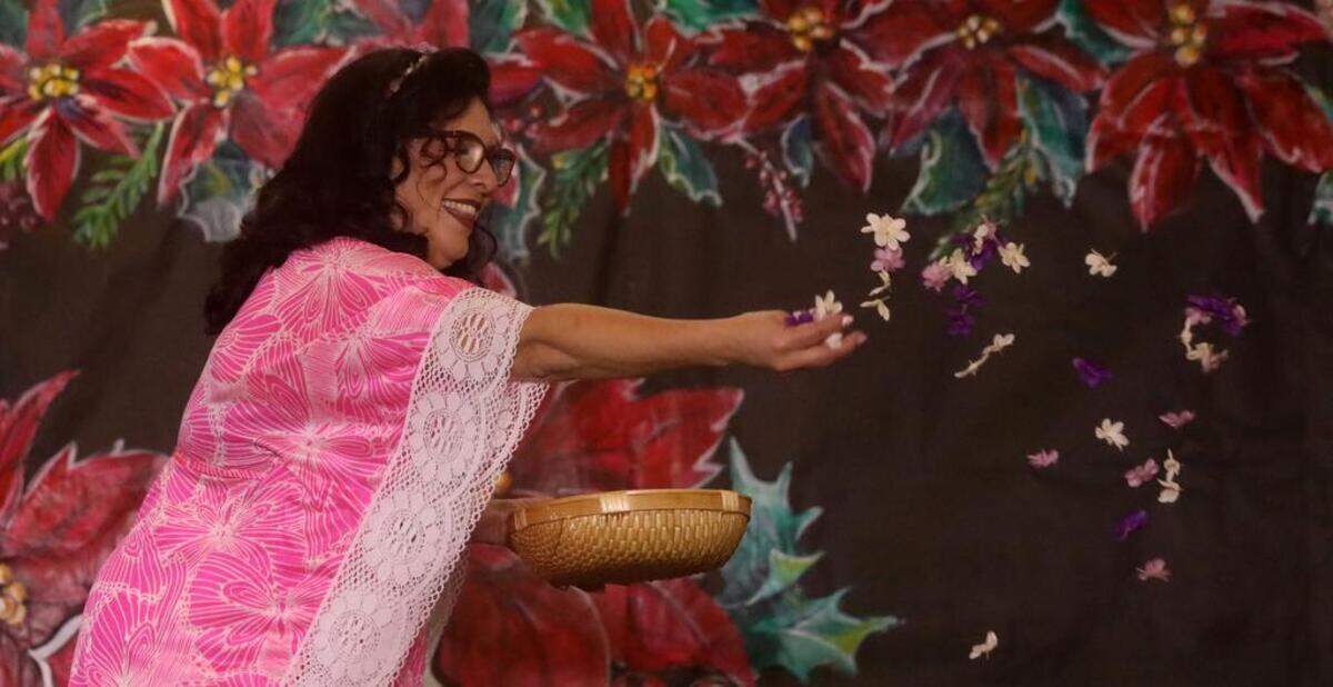 RomeAnna Saldívar sprinkles flowers during the 47th Fiesta Navideña Fashion Show at Fresno Fields on Dec. 4, 2022. The fundraiser was sponsored by the League of Mexican American Women.
