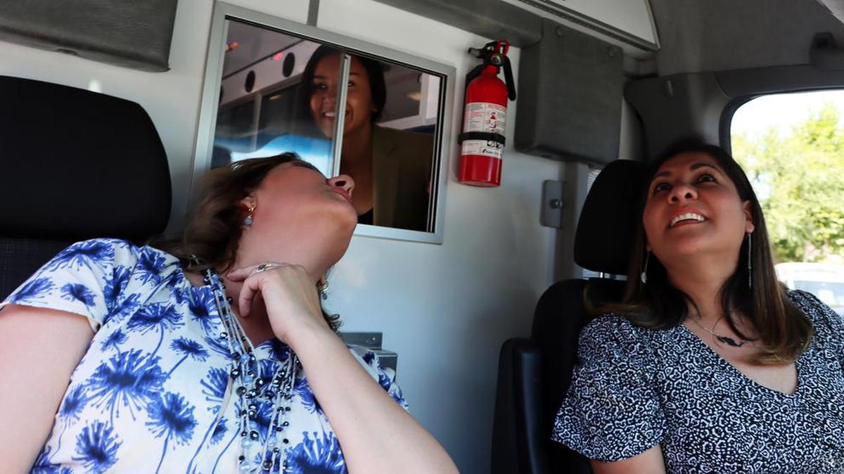 Fresno City Councilmember-elect Annalisa Perea looks at the front seat of a donated ambulance occupied by Naucalpan de Juárez, México officials Cynthia Elizondo and Ursula Cortes Fernández on Aug. 12, 2022.