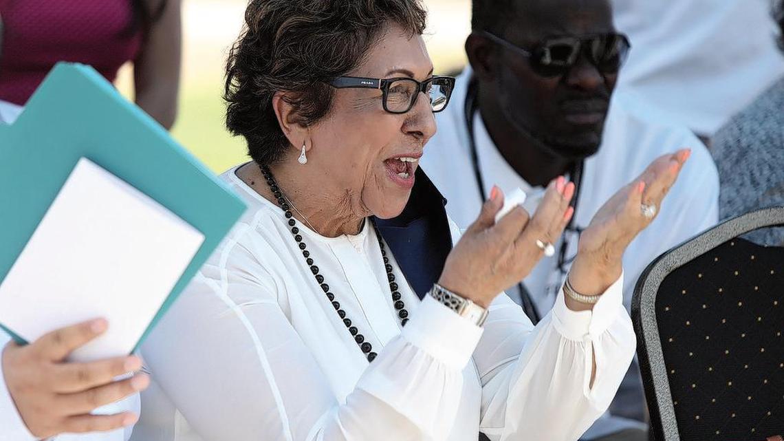Margarita Rocha, of Centro La Familia, applauds during announcement her group is among those receiving electric vehicles.