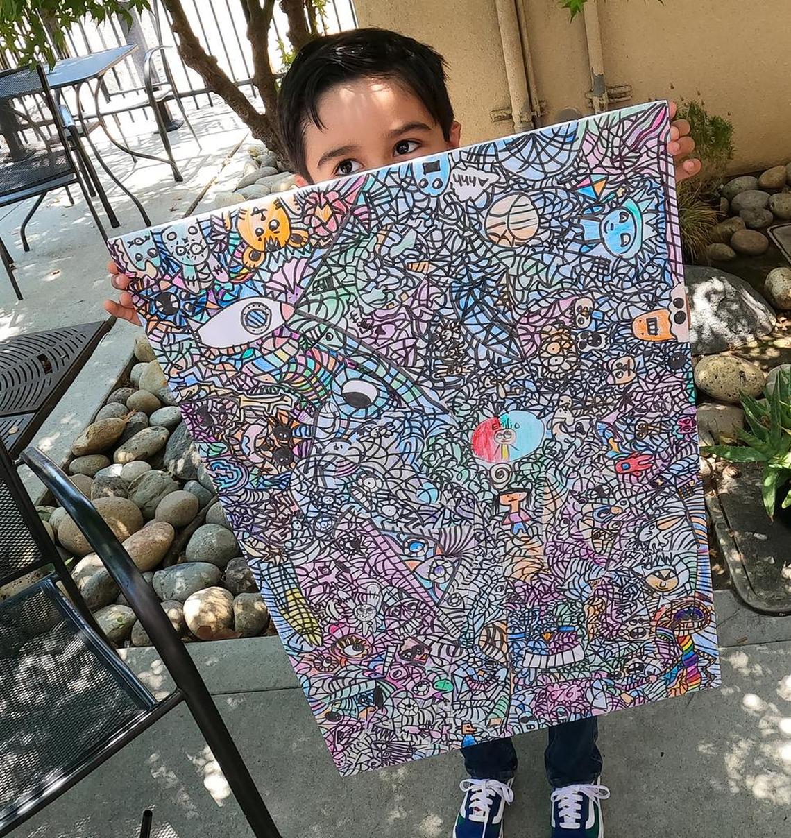 Emilio Barrera, 6, shows the drawing that fetched $904 on the NFT marketplace.