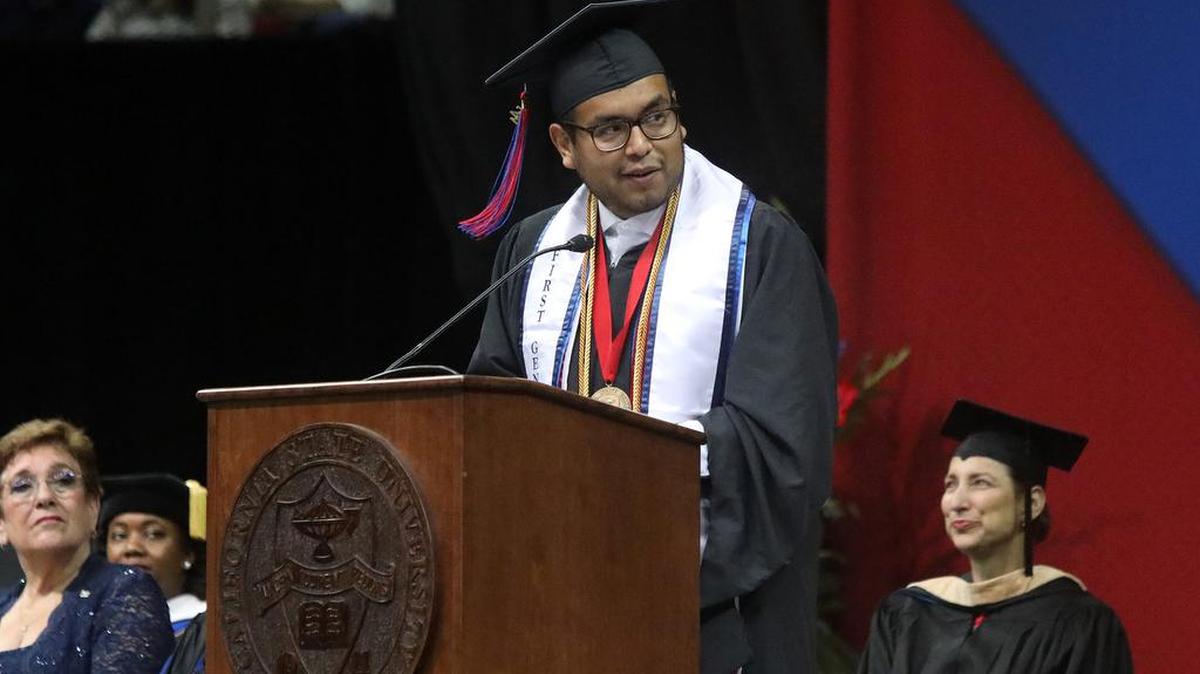 Saúl Pamatz Melgarejo, the graduate dean's medalist from the Kremen School of Education and Human Development, glances at his parents during his commencement speech on Friday..
