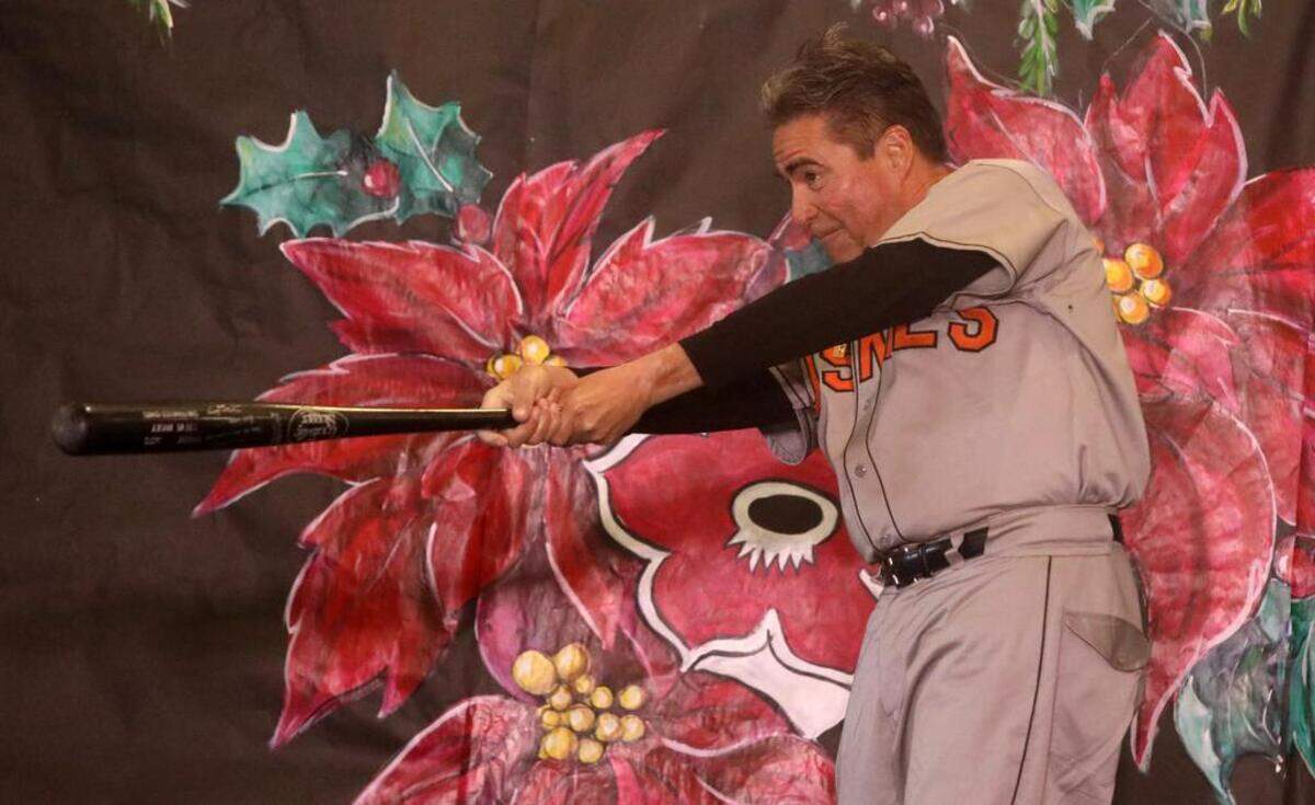 Jim Oftedal takes a swing during the 47th Fiesta Navideña Fashion Show at Fresno Fields on Dec. 4, 2022. The fundraiser was sponsored by the League of Mexican American Women.