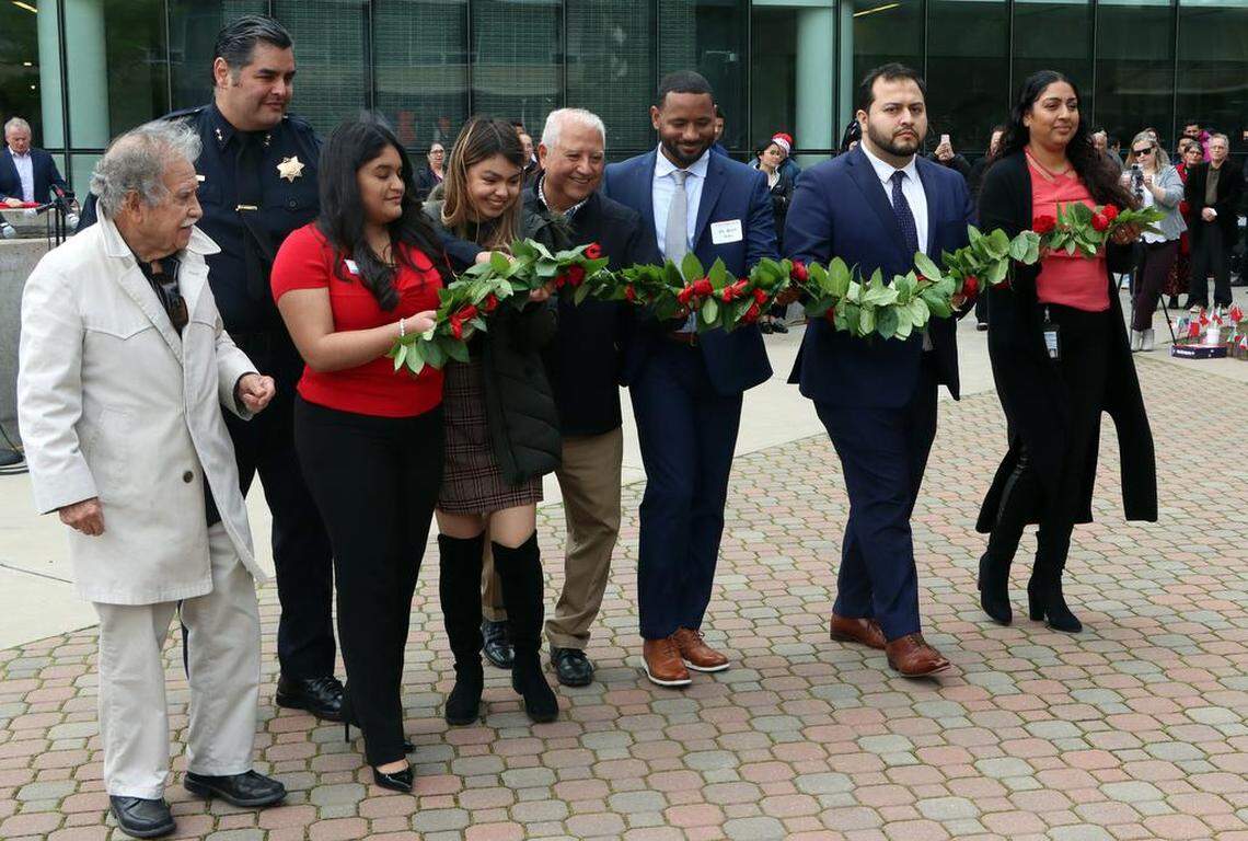 Paul Chávez helps with the garlanding ceremony during the Fresno State commemoration of his father, farmworker leader César E. Chávez, in the Peace Garden on March 22, 2023.