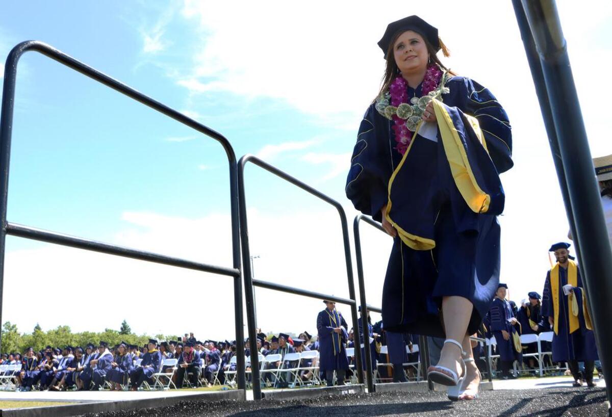 UC Merced graduate Vicky Espinoza walks to the stage during the May 15, 2022 commencement.