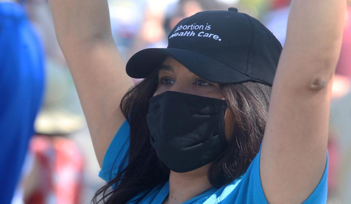 Valeria Rodríguez of Fresno joined about 1,000 supporters of abortion rights at the Rally for Roe on the corner of Blackstone and Nees in Fresno on May 14, 2022. Her sign reads: The rich abort, the poor die.