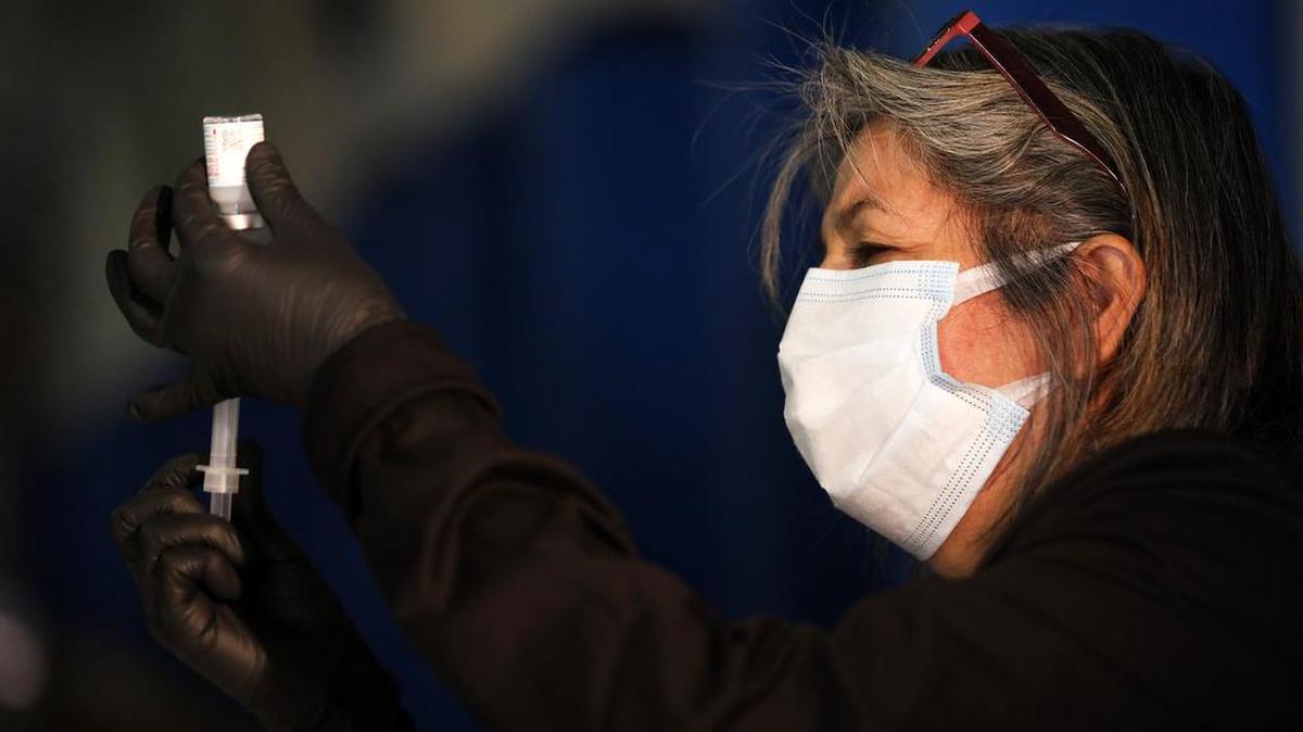 A Fresno County Department of Public Health worker prepares COVID-19 vaccinations that were used to vaccinate 50 farmworkers in Mendota on Jan. 25, 2021.