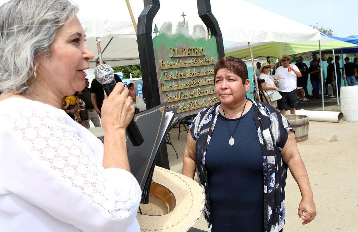 Half-Way Store owner Leticia Fernández gets an award from orgnizer Juanita González at the final day of the Joaquín Murrieta Horse Pilgrimmage on July 31, 2022.