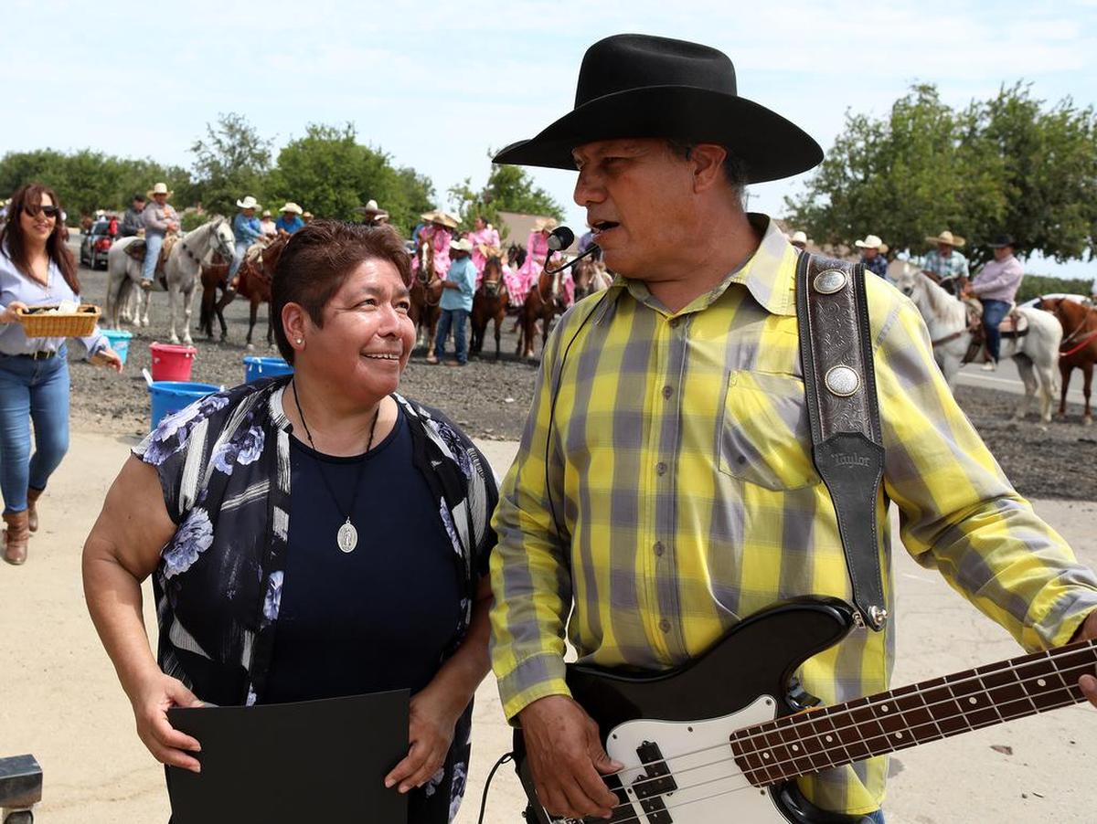 Half-Way Store owner Leticia Fernández gets serenaded by Benancio Esparza for her birthday during the final day of the Joaquín Murrieta Horse Pilgrimmage on July 31, 2022.
