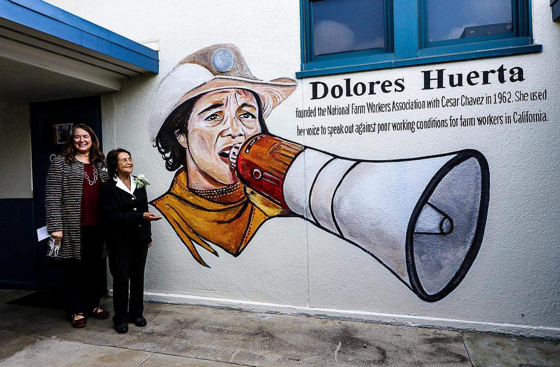 Principal Dr. Jennifer Meglemre and Dolores Huerta in front of one of the school’s mural after the renaming ceremony of the school &nbsp;to honor the&nbsp;91-year-old Latina&nbsp;icon&nbsp;and former teacher on Sept. 17.