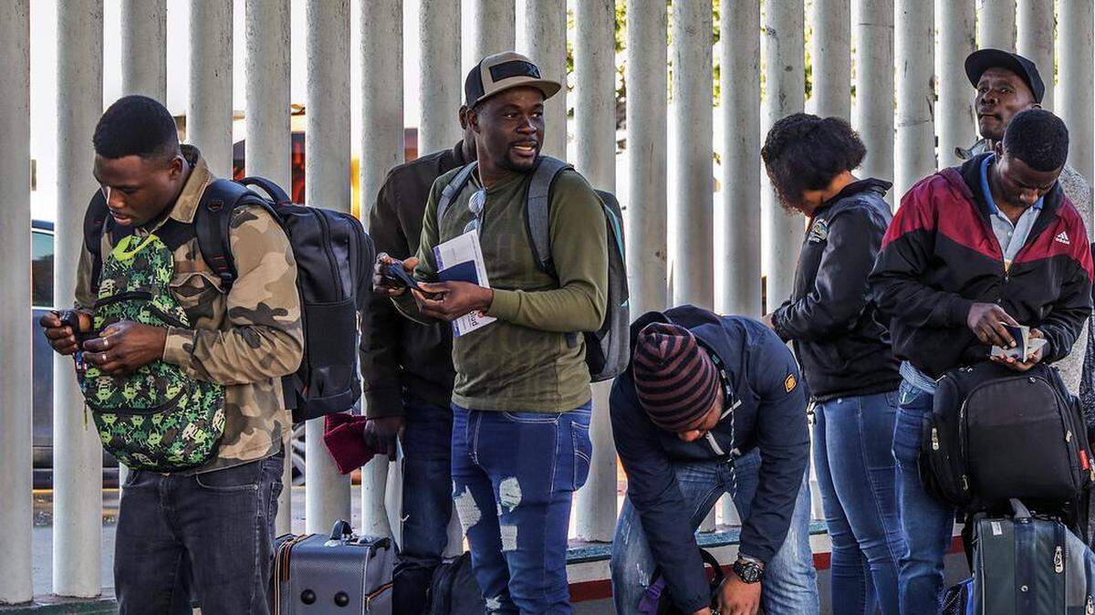 Migrants in Tijuana line up on Jan. 7 to cross into the United States where they are expected to file for asylum.
