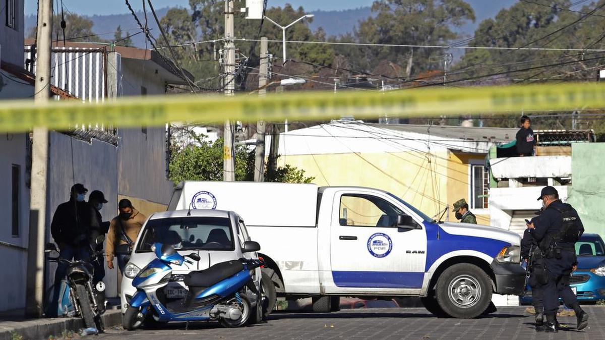 Mexican officials investigate the site in Atlixco, Puebla, México on Wednesday where nine people were assassinated.
