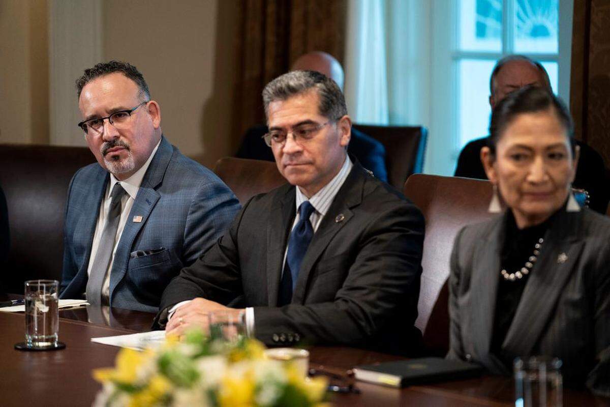Secretary of Education Miguel Cardona, Secretary of Health and Human Services Xavier Becerra, and Secretary of the Interior Deb Haaland listen as President Joe Biden speaks during a cabinet meeting at the White House in Washington, D.C., on Jan. 5.
