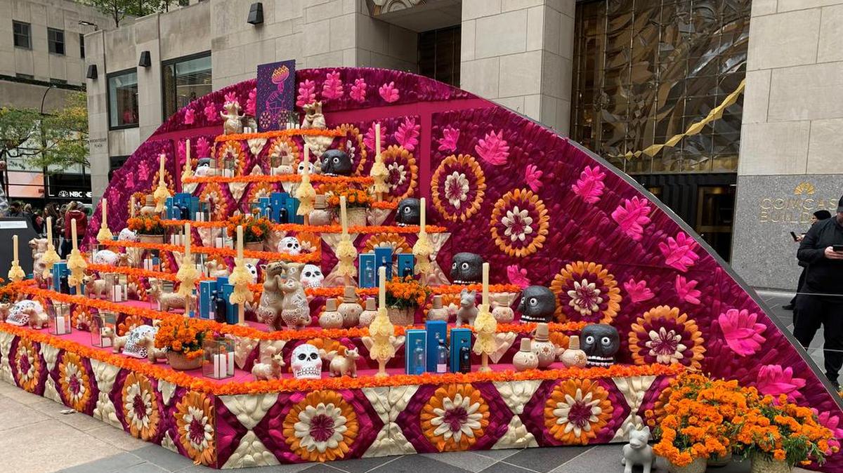 An enormous Day of the Dead altar – decorated with vibrantly colored petals, skulls, candles, tequila bottles, pots and Xoloitzcuintle dogs – was installed today at Rockefeller Center.