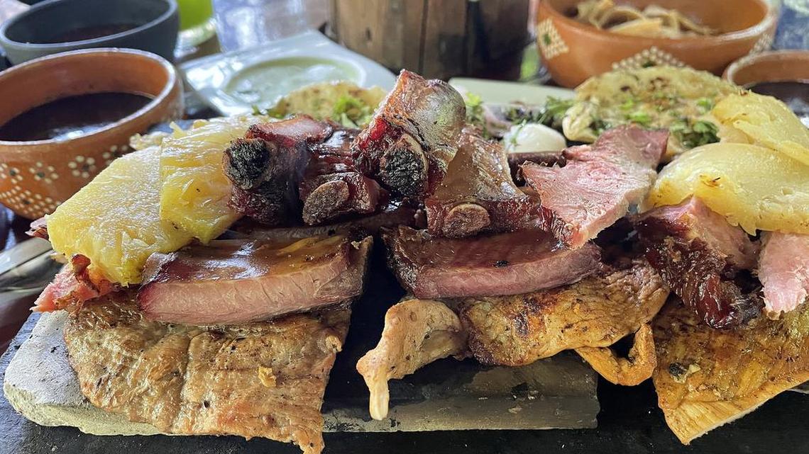 View of a dish prepared with smoked meat, longaniza and poc chuc served at the Achiote restaurant, town of Tikuch, Valladolid, state of Yucatán.