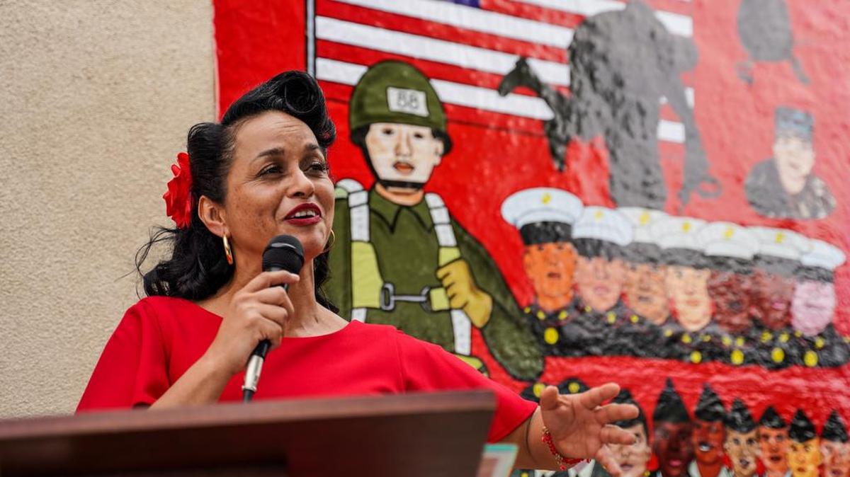 Livier Jiménez, with the veterans of the Logan neighborhoo, speaks during the 50-year anniversary of the Friendship Park between California and México.