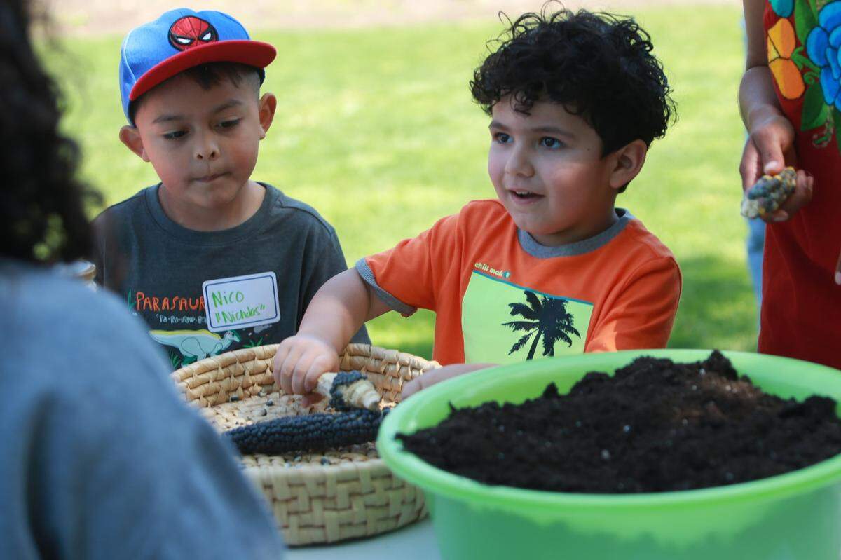 Sahir Padilla, right, and Nicholas Domíguez-Kelley, during an activity at Saturday’s Boom Oaxaca kids’ maize-planting workshop at Arte Américas.