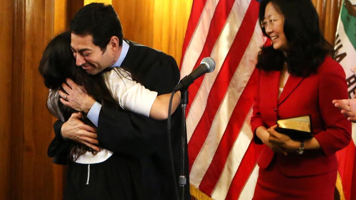 SACRAMENTO 01/05/2015: Judge Lucy Koh, right, with her husband, Justice Mariano-Florentino Cuellar, left, at his swearing-in ceremony in 2015. President Joe Biden in 2021 nominated her to serve on the 9th Circuit Court of Appeals.