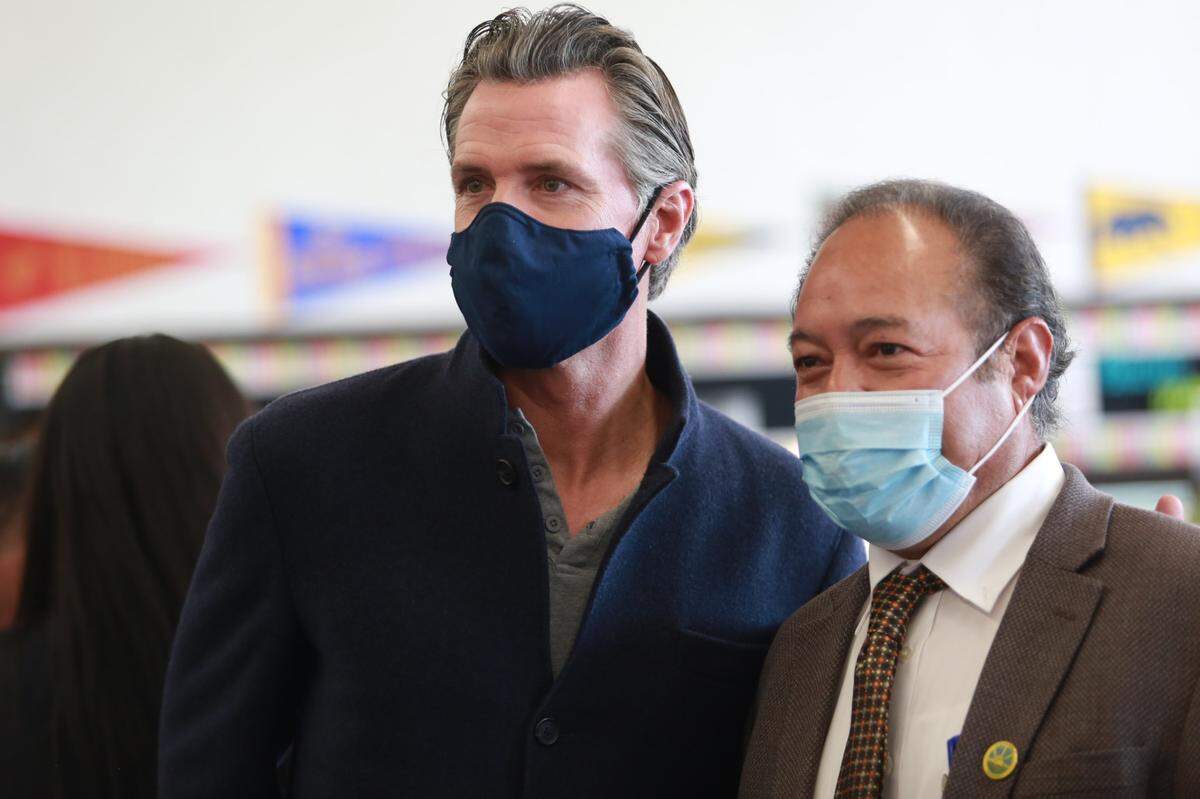 Avenal Mayor Álvaro Preciado, right, with Gov. Gavin Newsom, during his visit to a COVID-19 vaccine clinic in Avenal to promote COVID-19 vaccinations and booster shots on Nov. 16, 2021.
